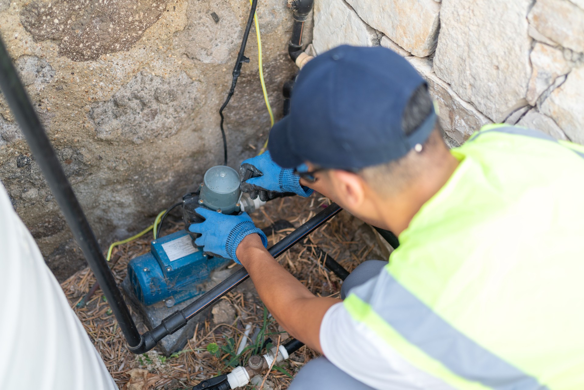 Plumber Repairing Water Pump Motor Of Water Storage Tank