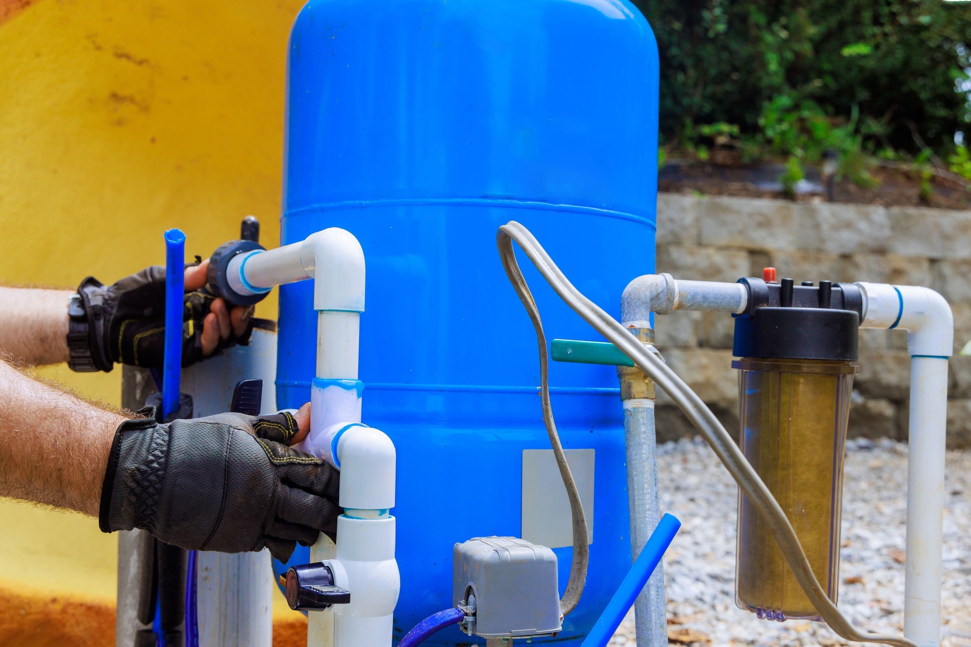 Installing artesian water well system in residential backyard on sunny afternoon