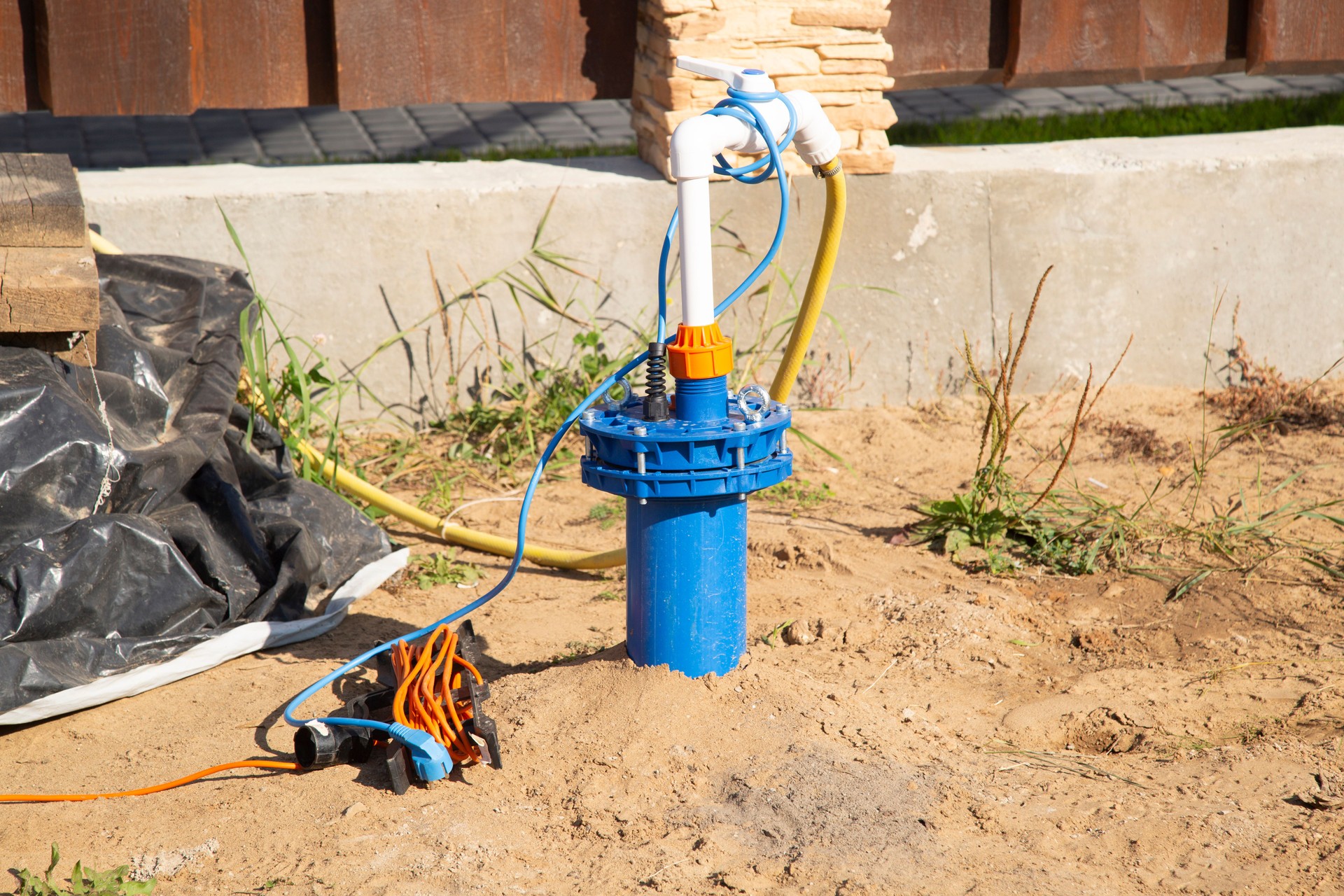 A water well for a pump near the house for private use.